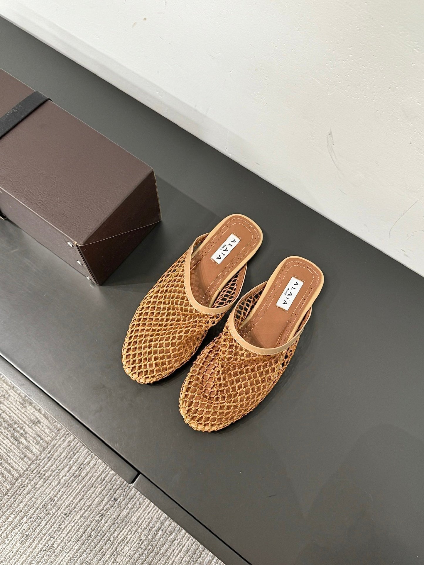 ALAIA FLAT MULES IN COPPER BROWN MESH FISHNET