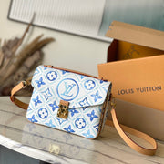 POCHETTE MÉTIS 25 IN LAGOON BLUE MONOGRAM TILES CANVAS GOLD HARDWARE