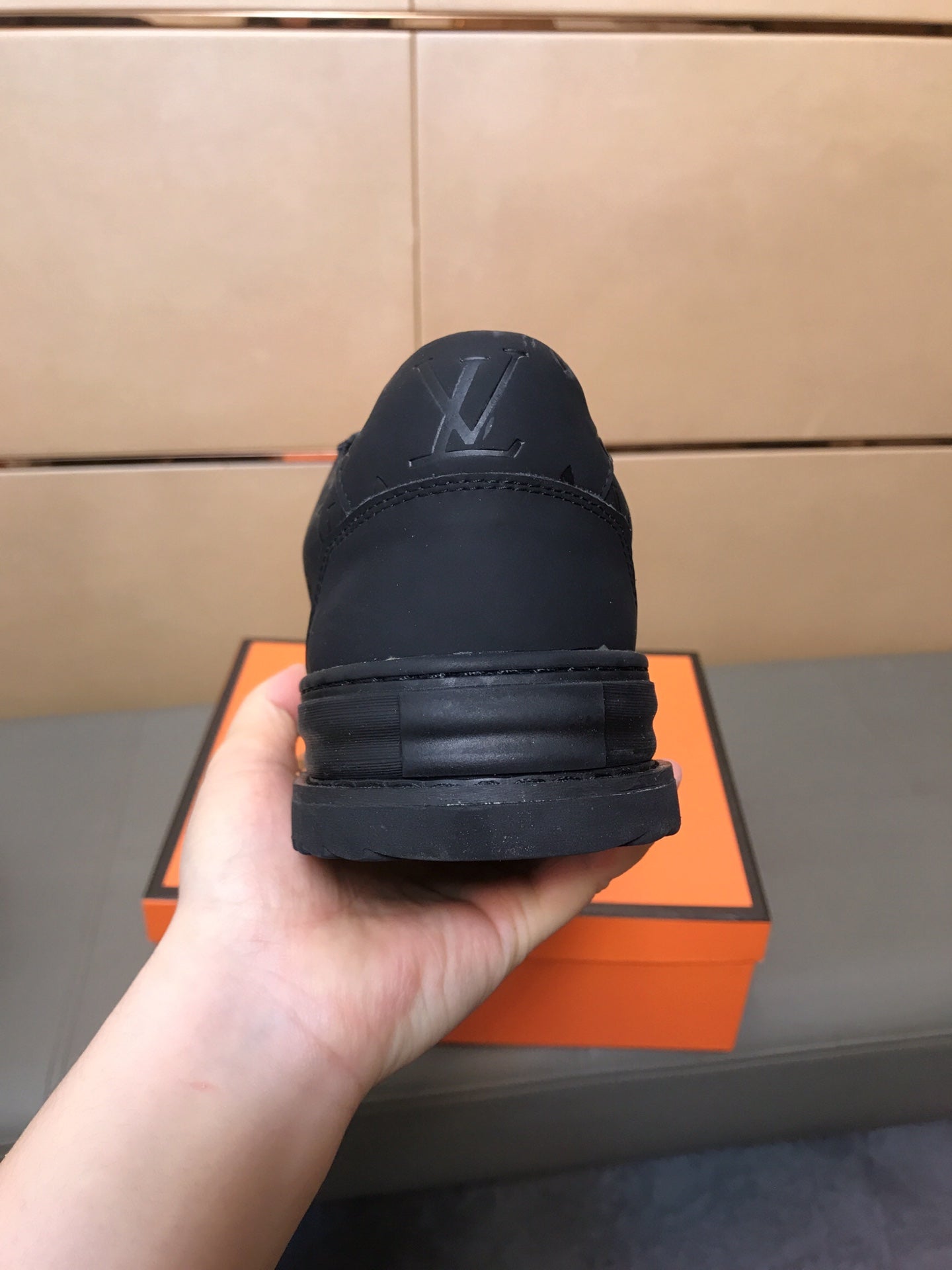 LV TRAINER IN EMBOSSED BLACK SUEDE